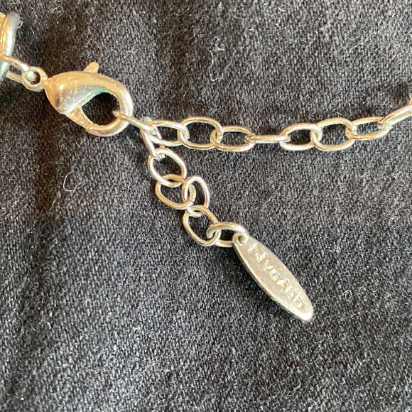 Nygard necklace intertwined with ribbon and silver and pink bangles. - Picture 4 of 6